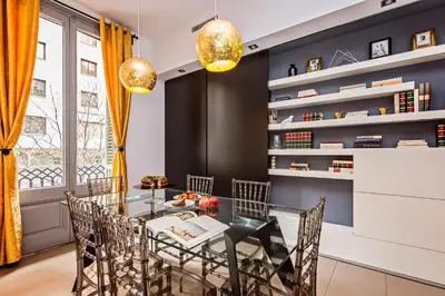 a dining room with a glass table and chairs at Sweett - Urqui City Center in Barcelona