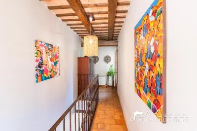 a hallway with two large paintings on the wall at Charming Villa Tamarindo in Olivella