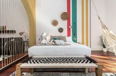 a bedroom with a bed with a bench in it at Sweett - Loft Villa Olimpica Beach in Barcelona