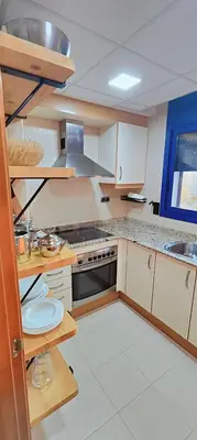 a kitchen with white cabinets and a stove top oven at Vilanova Beach Stay in Vilanova i la Geltrú