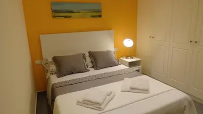 a bedroom with a bed with two towels on it at Apartamento zona playa de San Sebastian in Sitges