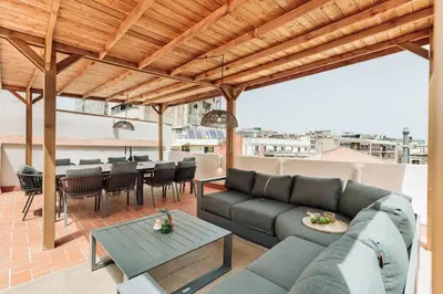a patio with a table and chairs on a roof at Capaccio - 2 bedrooms and terrace in Ciutat Vella in Barcelona