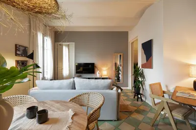 a kitchen with white cabinets and a potted plant at Bawah - 2 bedrooms in Eixample Esquerra in Barcelona