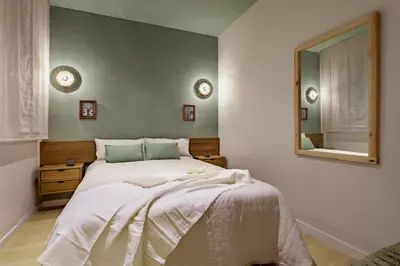 a bedroom with a bed and a book shelf at Liang - 3 bedrooms in Eixample Esquerra in Barcelona