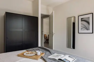 a bedroom with a bed with two books on it at Punta - 3 bedrooms with pool in Les Corts in Barcelona