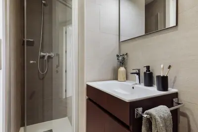 a bedroom with a bed with an orange on it at Punta - 3 bedrooms with pool in Les Corts in Barcelona