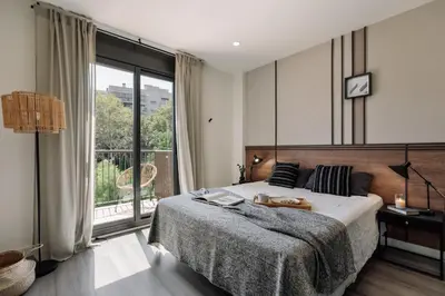 a living room with a couch and a large window at Punta - 3 bedrooms with pool in Les Corts in Barcelona