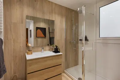 a bedroom with a bed with a large wooden headboard at Afrera - 2 bedrooms and terrace in Sant Gervasi in Barcelona