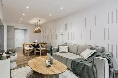 a dining room and living room with a table and chairs at Canneti - 3 bedrooms in Sagrada Família in Barcelona
