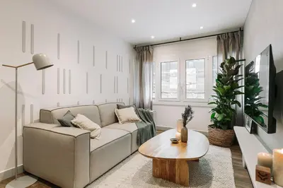 a kitchen and dining room with a wooden table and chairs at Canneti - 3 bedrooms in Sagrada Família in Barcelona