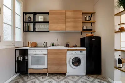 a kitchen with a washing machine and a refrigerator at Takari - 1 bedroom and balcony in Gràcia in Barcelona