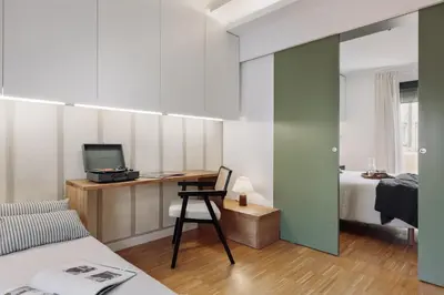 a bedroom with a white dresser and a mirror at Celoni - 1 bedroom and office in Sagrada Família in Barcelona