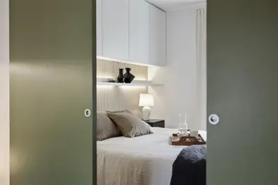 a bedroom with a bed and a desk with a television at Celoni - 1 bedroom and office in Sagrada Família in Barcelona