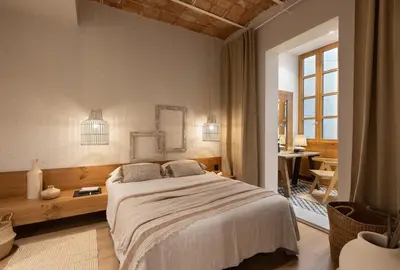 a bedroom with a large bed and a table at Malay - 3 bedrooms in Eixample Dreta in Barcelona