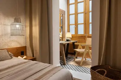 a bedroom with a large bed and a table at Malay - 3 bedrooms in Eixample Dreta in Barcelona