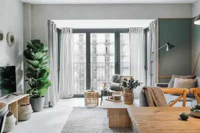 a living room with a table and a dining room at Sare - 3 bedrooms in Eixample Esquerra in Barcelona