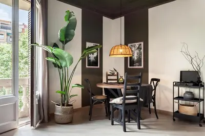 a room with a table with a lamp and a mirror at Lendu - 2 bedrooms and balcony in Sant Antoni in Barcelona