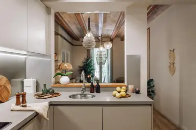a living room with a couch and three pictures on the wall at Sande - 2 bedrooms and balcony in Eixample Dreta in Barcelona