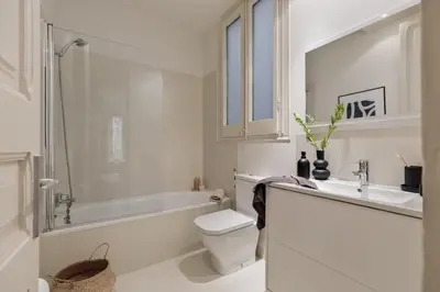 a bedroom with a large bed with a striped wall at Sinan - 2 bedrooms and balcony in Sant Gervasi in Barcelona