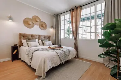 a bedroom with a large bed with three pictures on the wall at Jaen - 2 bedrooms and office in Sant Gervasi in Barcelona