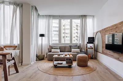 a bedroom with a bed with a hat on the wall at Genave - 2 bedrooms in Eixample Esquerra in Barcelona