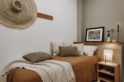 a bedroom with a bed with a large wooden headboard at Genave - 2 bedrooms in Eixample Esquerra in Barcelona