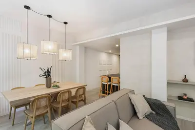 a bedroom with a large bed and a chair at Palinuro - 3 bedrooms in Sant Antoni in Barcelona