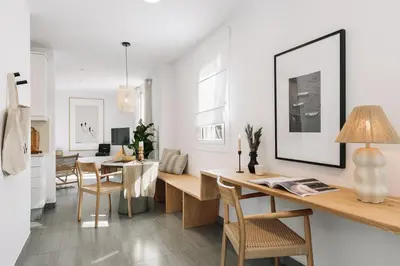 a kitchen and living room with a table and chairs at Soffio - Studio and terrace in Gràcia in Barcelona