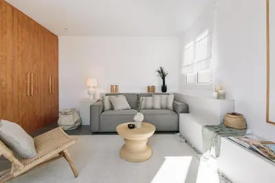 a bedroom with a bed in a white room at Soffio - Studio and terrace in Gràcia in Barcelona