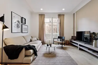 a living room with a couch and a tv at Costa - 3 bedrooms, balcony in Eixample Esquerra in Barcelona