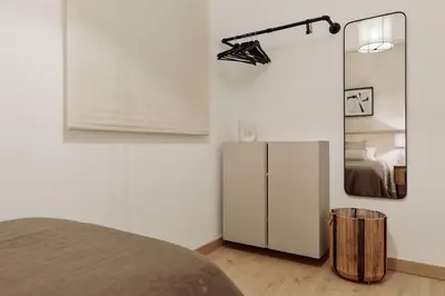 a bedroom with a bed and a desk with a chair at Costa - 3 bedrooms, balcony in Eixample Esquerra in Barcelona