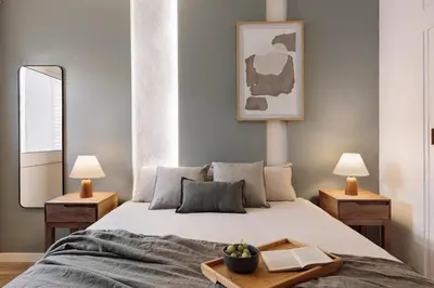 a bedroom with a bed and a table with a lamp at Iztapa - 4 bedrooms in Eixample Esquerra in Barcelona
