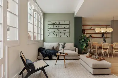 a kitchen with a stainless steel refrigerator and two bar stools at Peten - 3 bedrooms, terrace and balcony in Gràcia in Barcelona