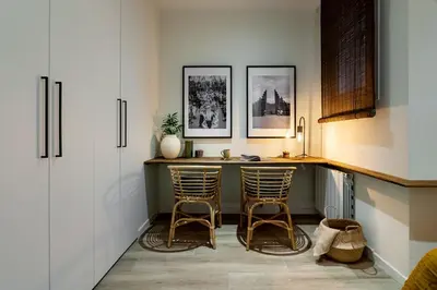 a kitchen with two bar stools and a counter at Natuna - 3 bedrooms in Eixample Esquerra in Barcelona