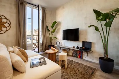 a living room with a white couch and a large window at Natuna - 3 bedrooms in Eixample Esquerra in Barcelona