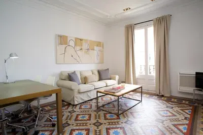 a white living room with a couch and a table at BarcelonaForRent The Claris Suites II in Barcelona