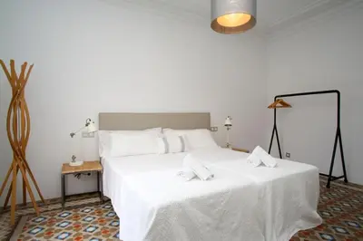 a bedroom with a white bed with two towels on it at BarcelonaForRent The Claris Suites II in Barcelona