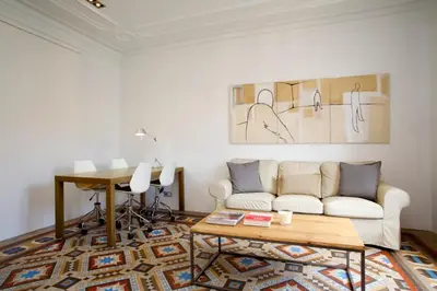 a living room with a white couch and a table at BarcelonaForRent The Claris Suites II in Barcelona