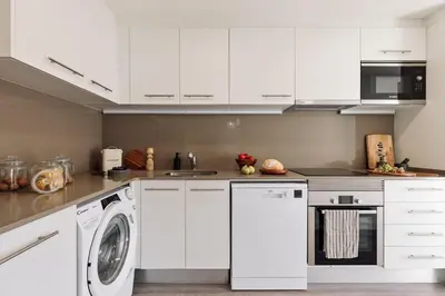 a living room with a couch and a table at Cervantes - 1 bedroom and pool in Les Corts in Barcelona
