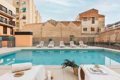 a bedroom with a bed with white cabinets at Cervantes - 1 bedroom and pool in Les Corts in Barcelona