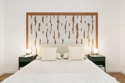 a small bedroom with a bed and a table at Velino - 4 bedrooms and office in Sant Antoni in Barcelona