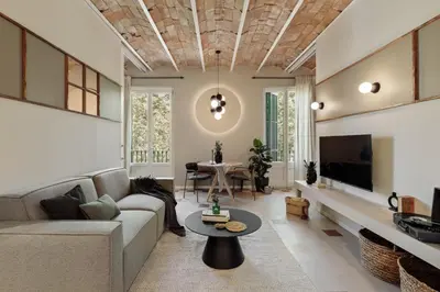 a living room with a couch and a table at Yaki - 2 bedrooms and balcony in Eixample Dreta in Barcelona