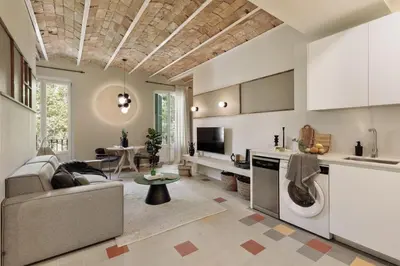 a living room with a table and chairs and a television at Yaki - 2 bedrooms and balcony in Eixample Dreta in Barcelona