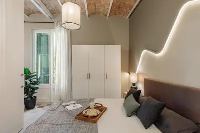 a bedroom with a bed with a tray on it at Yaki - 2 bedrooms and balcony in Eixample Dreta in Barcelona