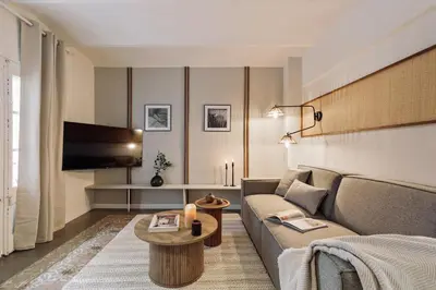 a bedroom with a bed with a desk and a desk at Poblet - 2 bedrooms and balcony in Poblenou in Barcelona