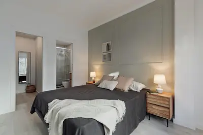 a black cabinet in a room with a mirror at Noguera - 2 bedrooms in Eixample Esquerra in Barcelona