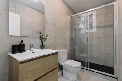 a kitchen with a table with a bowl of fruit at Noguera - 2 bedrooms in Eixample Esquerra in Barcelona