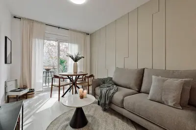 a living room with a couch and a table at Noguera - 2 bedrooms in Eixample Esquerra in Barcelona