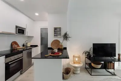 a living room with a couch and a table at Noguera - 2 bedrooms in Eixample Esquerra in Barcelona
