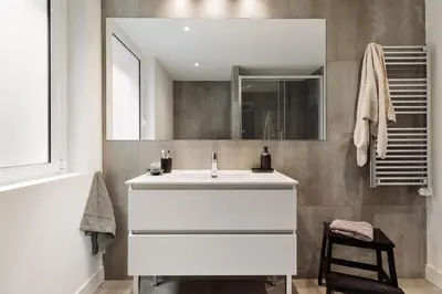 a bedroom with a bed and a desk with a mirror at Champey - 2 bedrooms and balcony in Sant Gervasi in Barcelona